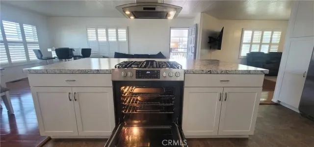 a kitchen with granite countertop a stove and a sink