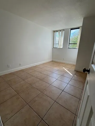 a kitchen with stainless steel appliances granite countertop a sink a stove a microwave and a refrigerator