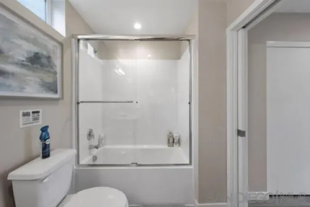 a bathroom with a shower and a toilet