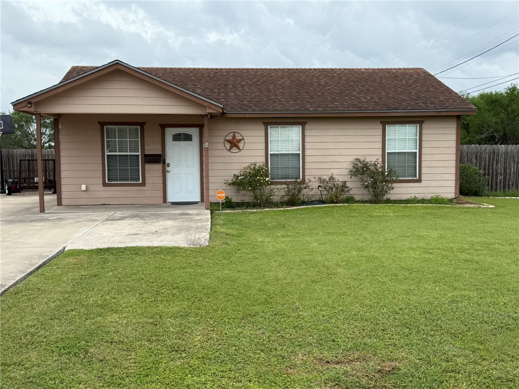 408 North Ave C Bishop, TX 78343 - Photo 1 of 12 a front view of a house with a yard