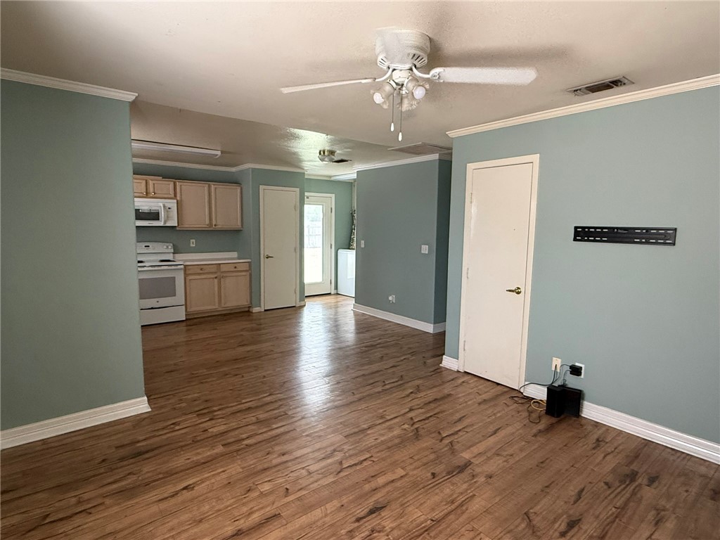 408 North Ave C Bishop, TX 78343 - Photo 2 of 12 a view of a kitchen with hardwood floor and a ceiling fan