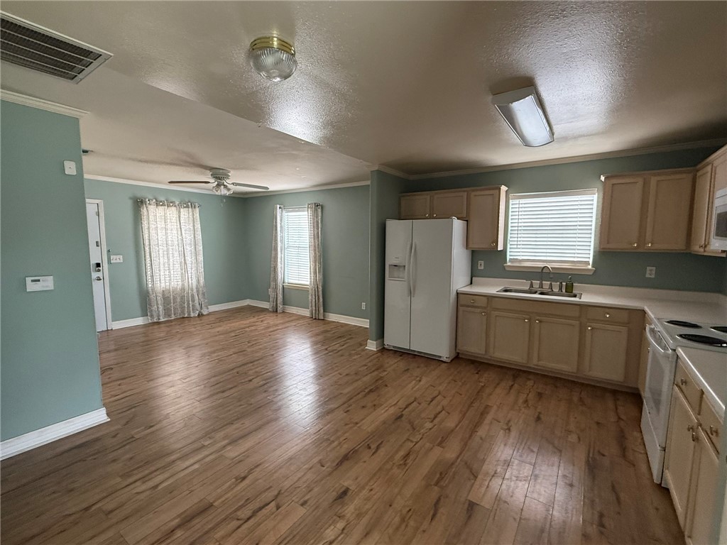 408 North Ave C Bishop, TX 78343 - Photo 4 of 12 a view of a kitchen with wooden floor and electronic appliances