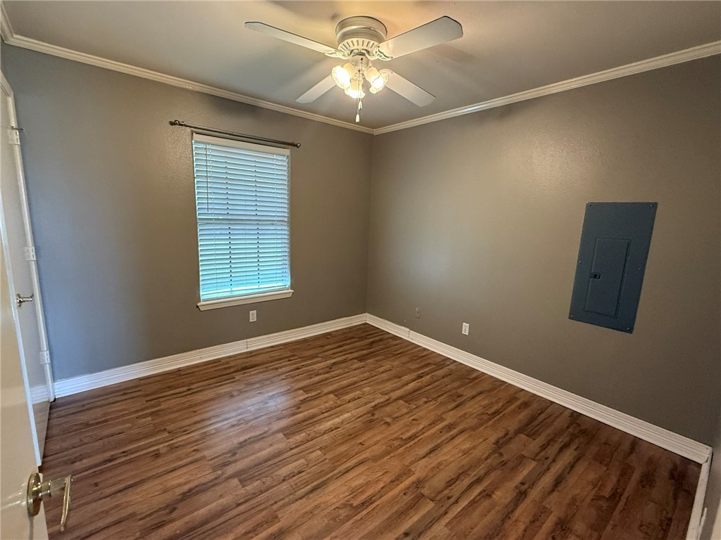 408 North Ave C Bishop, TX 78343 - Photo 8 of 12 a view of an empty room with window and wooden floor