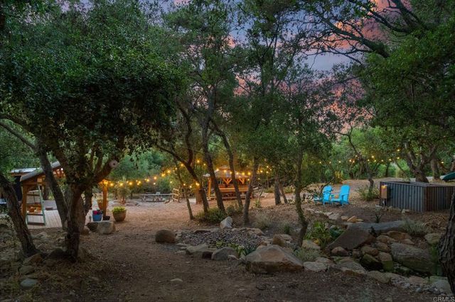 a view of a wooden bench and chair in the yard