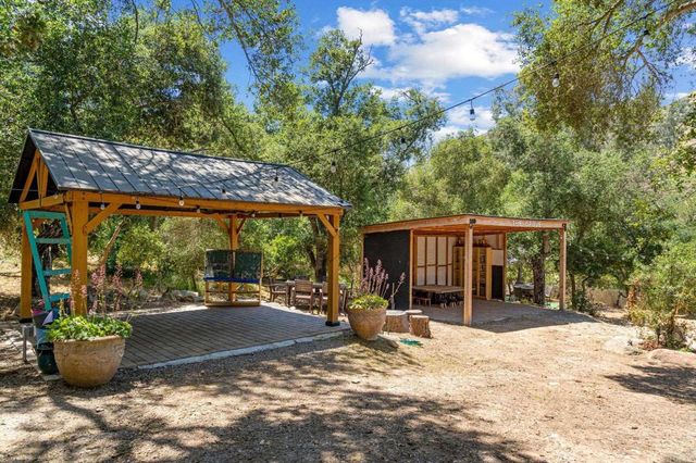 a front view of house with yard outdoor seating and barbeque oven