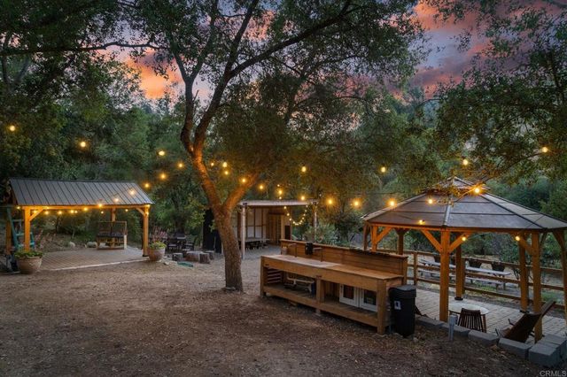 a backyard of a house with table and chairs