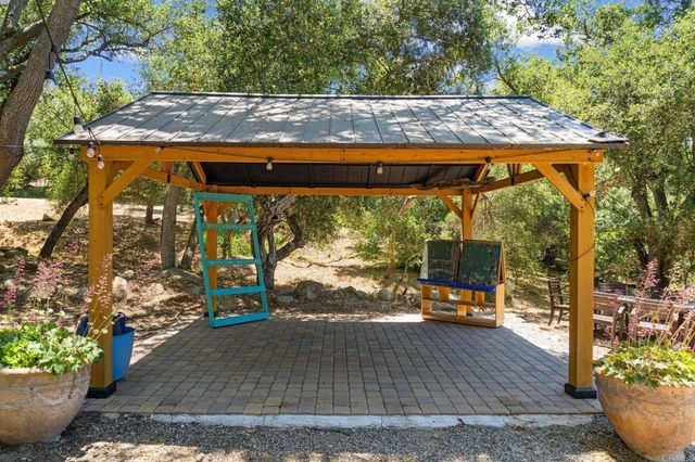 a backyard of a house with table and chairs