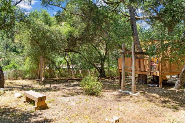 an empty room with windows and fireplace