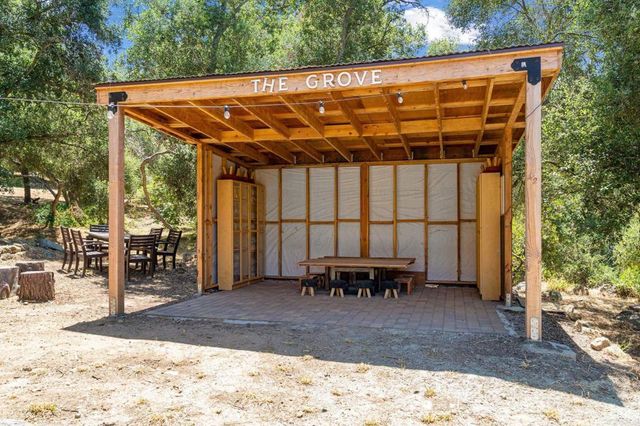 a kitchen with stainless steel appliances granite countertop a refrigerator a sink a stove a microwave and wooden floor