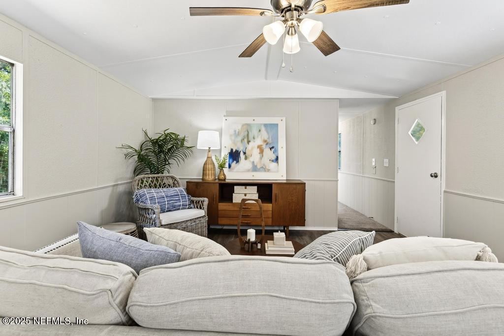 28 Neighbors Cove Road Orange Park, FL 32065 - Photo 15 of 56 a living room with furniture and a chandelier