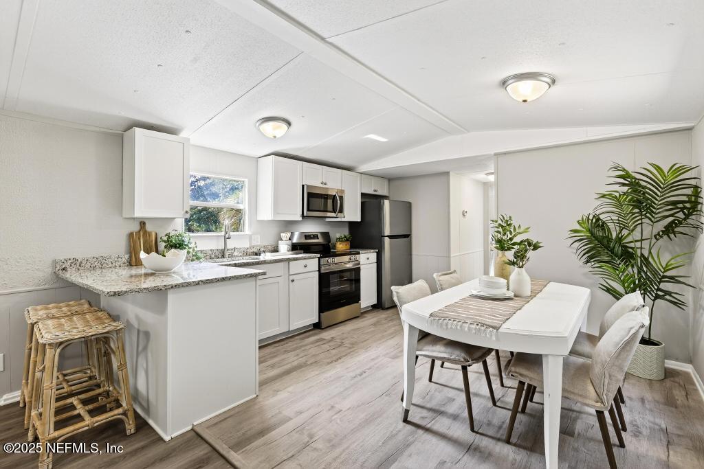 28 Neighbors Cove Road Orange Park, FL 32065 - Photo 17 of 56 a kitchen with a table and chairs in it