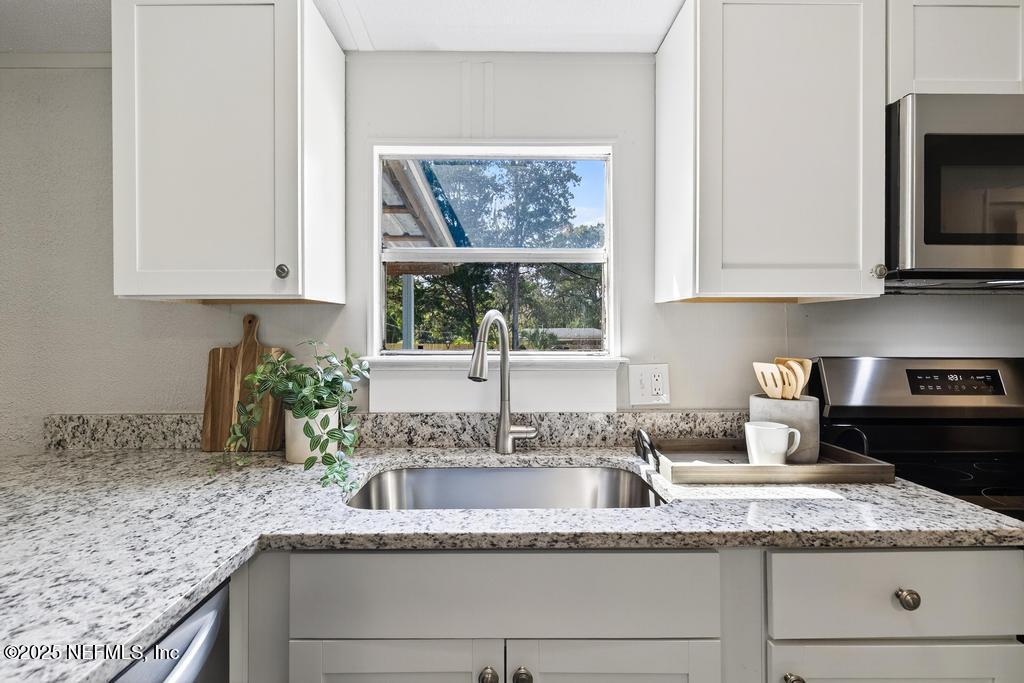 28 Neighbors Cove Road Orange Park, FL 32065 - Photo 20 of 56 a kitchen with granite countertop a sink a window and a granite counter tops