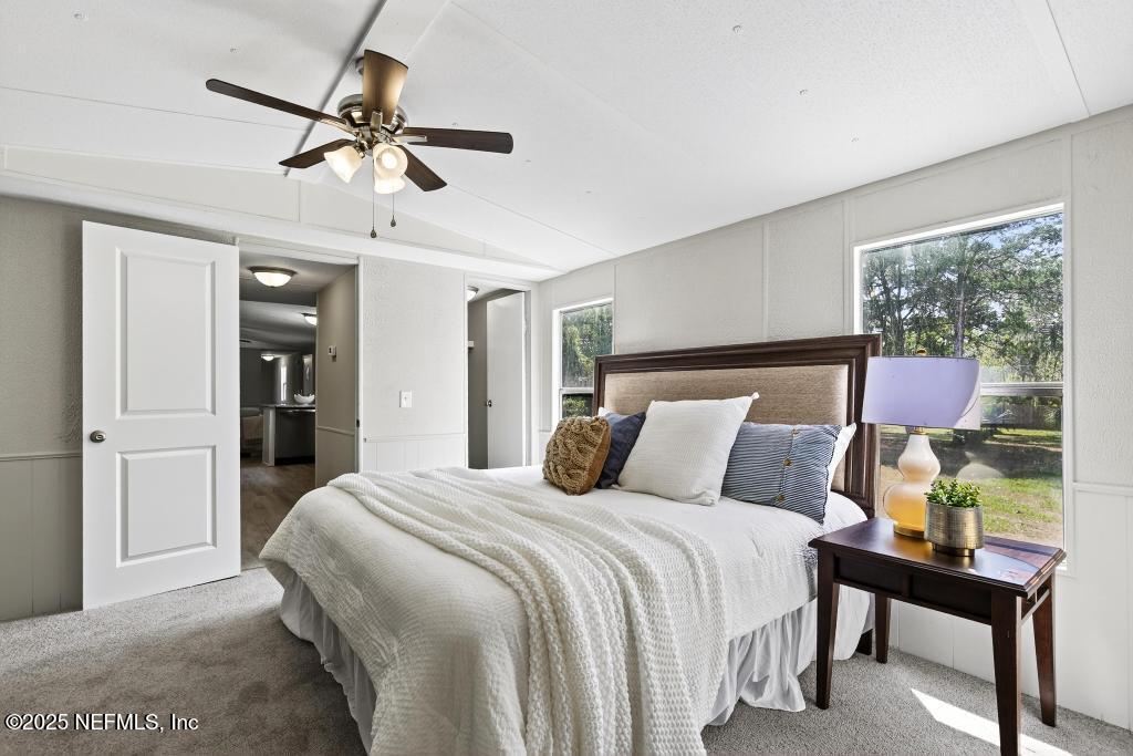 28 Neighbors Cove Road Orange Park, FL 32065 - Photo 33 of 56 a bedroom with a bed and a chandelier