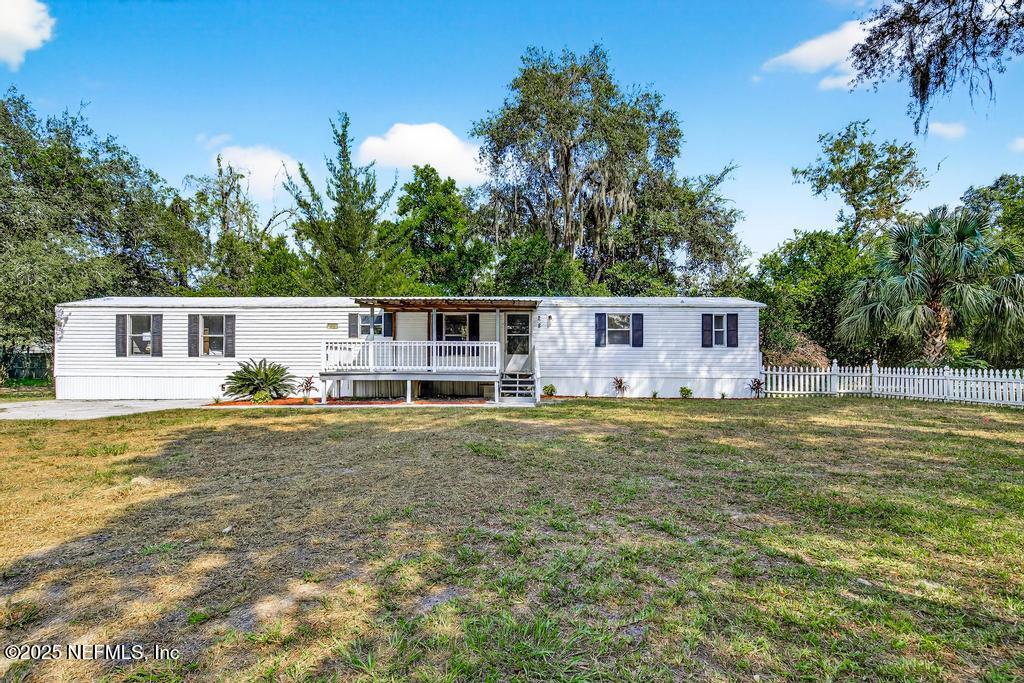 28 Neighbors Cove Road Orange Park, FL 32065 - Photo 4 of 56 a front view of a house with swimming pool having outdoor seating