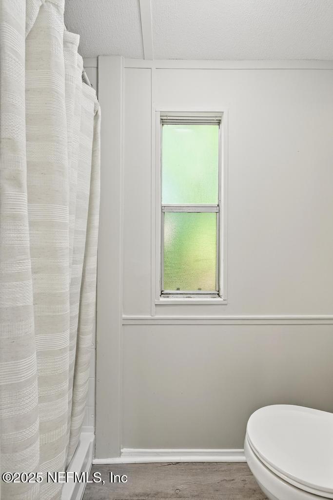 28 Neighbors Cove Road Orange Park, FL 32065 - Photo 41 of 56 a white toilet sitting next to a shower curtain