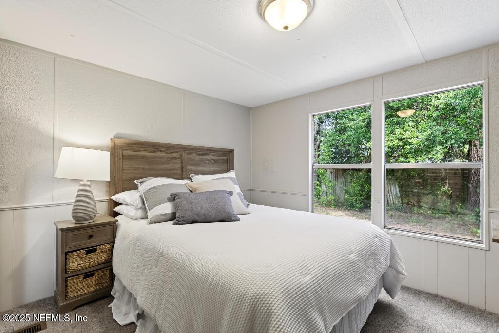 28 Neighbors Cove Road Orange Park, FL 32065 - Photo 43 of 56 a bedroom with a large bed and a large window