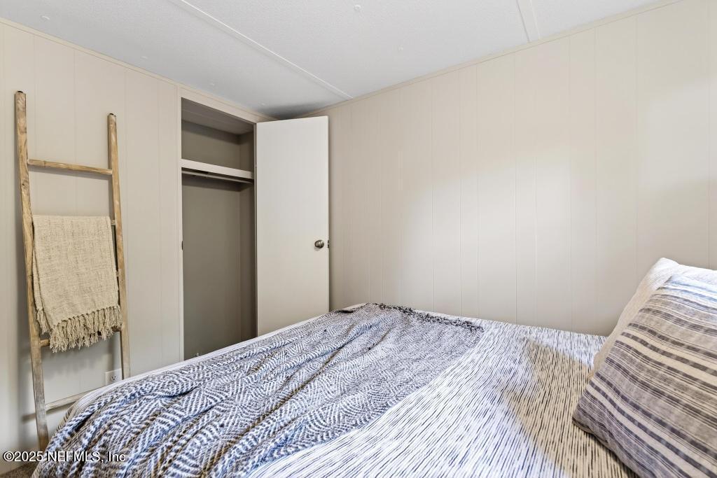 28 Neighbors Cove Road Orange Park, FL 32065 - Photo 49 of 56 a bedroom with a bed and a mirror