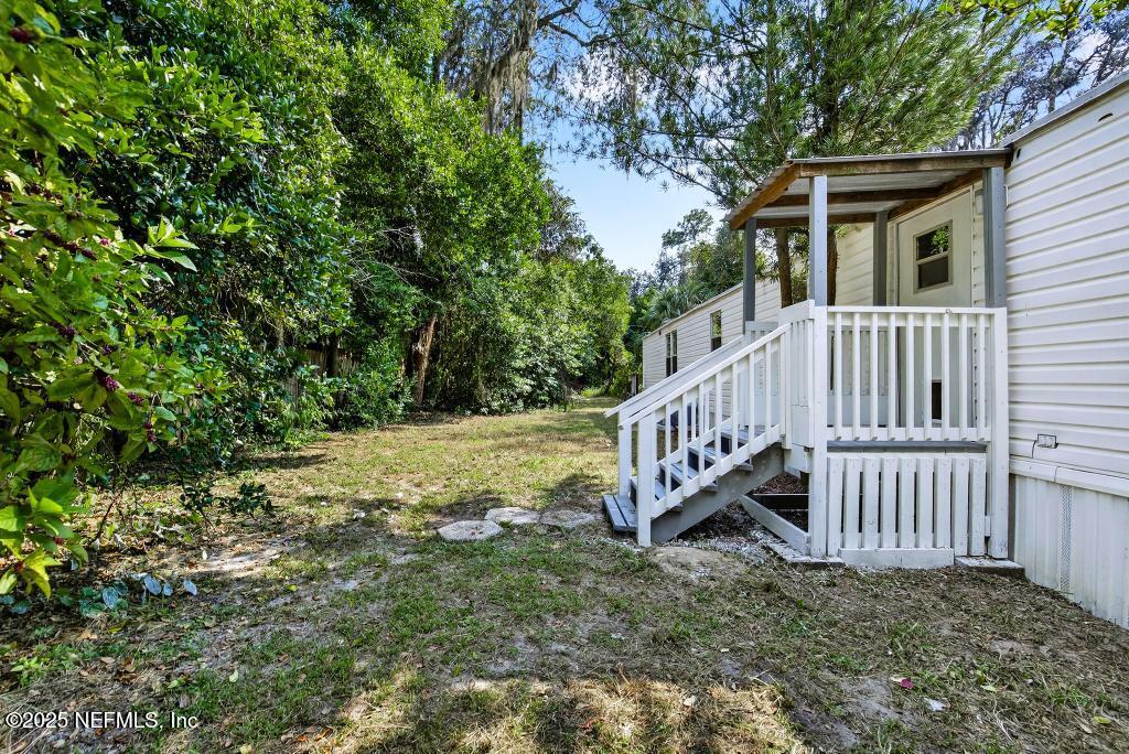 28 Neighbors Cove Road Orange Park, FL 32065 - Photo 50 of 56 a view of a house with a yard and wooden deck