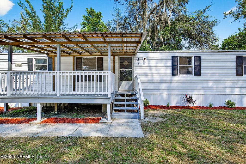 28 Neighbors Cove Road Orange Park, FL 32065 - Photo 5 of 56 a view of a house with a yard and sitting area