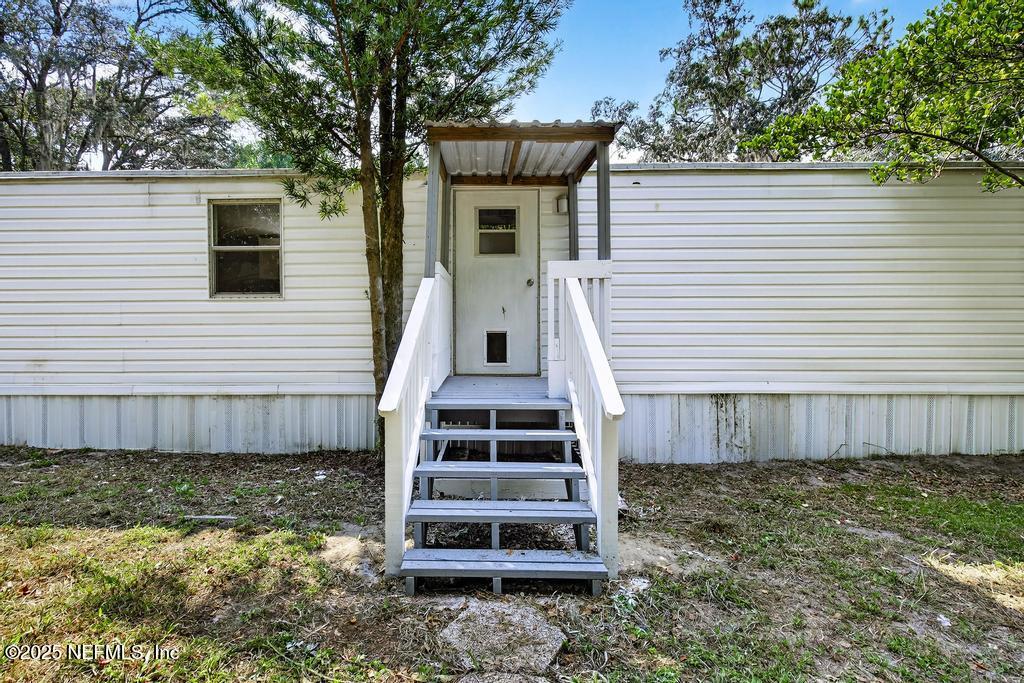 28 Neighbors Cove Road Orange Park, FL 32065 - Photo 51 of 56 a view of a house with backyard and wooden fence