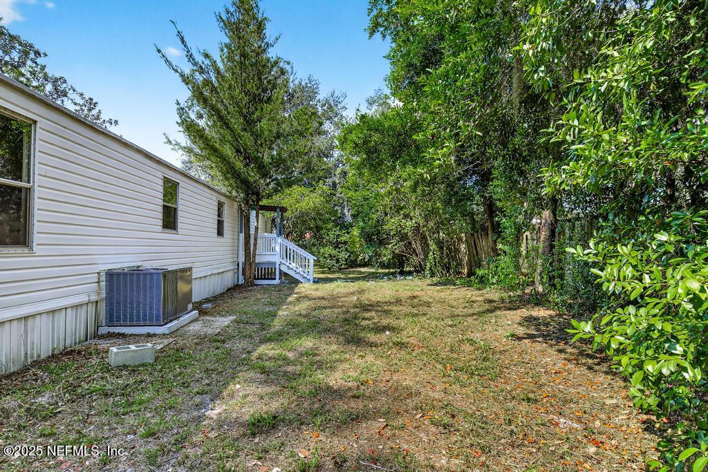 28 Neighbors Cove Road Orange Park, FL 32065 - Photo 52 of 56 a view of a backyard with large trees