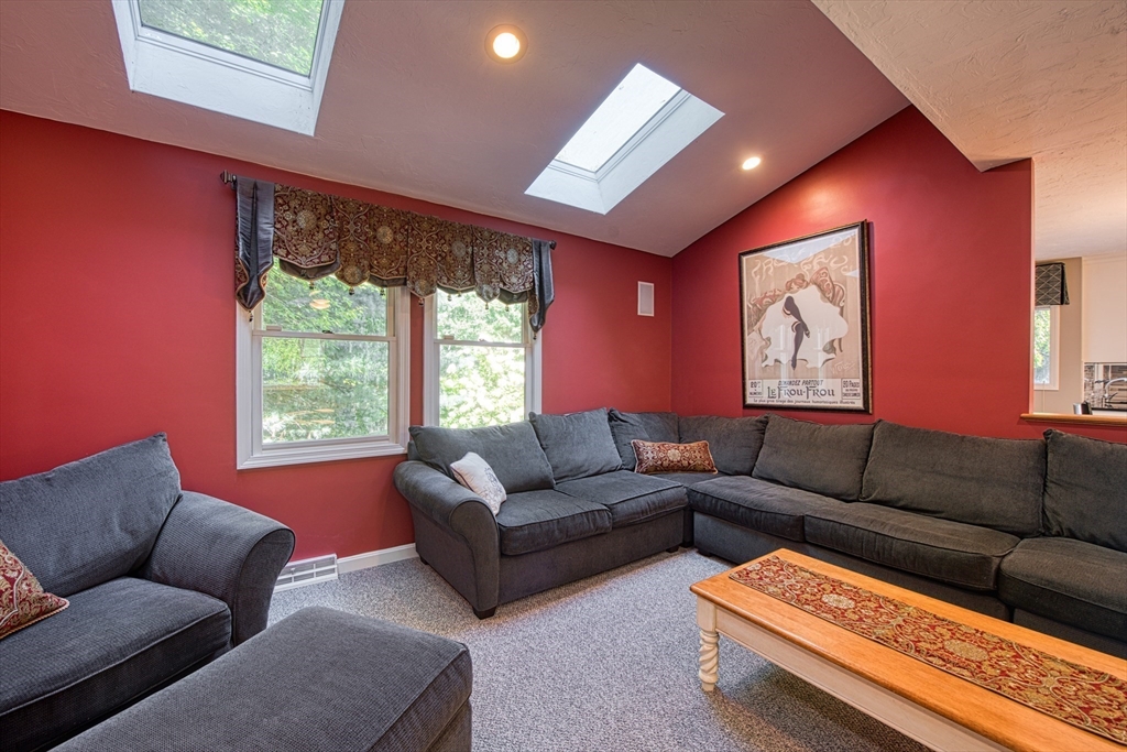 60 Aspen Road Sharon, MA 02067 - Photo 8 of 42 a living room with furniture a large window and a flat screen tv