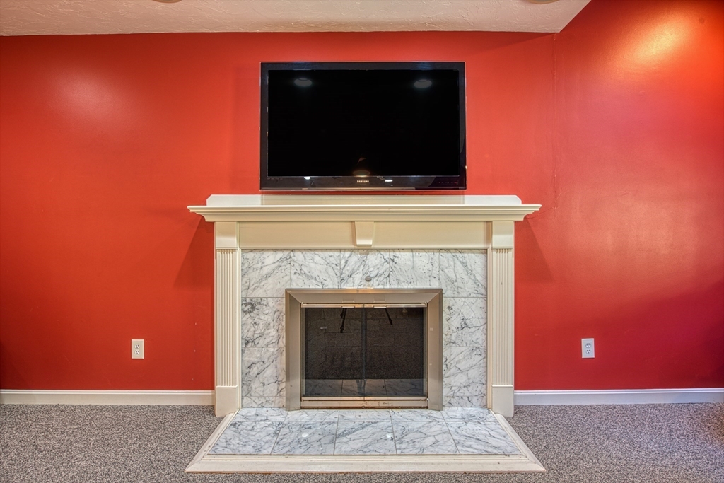 60 Aspen Road Sharon, MA 02067 - Photo 10 of 42 a living room with a fireplace and a fireplace
