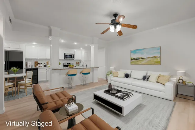 a living room with furniture kitchen view and a dining table