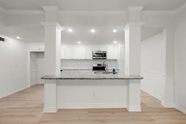 a view of kitchen with stainless steel appliances granite countertop refrigerator stove microwave and oven