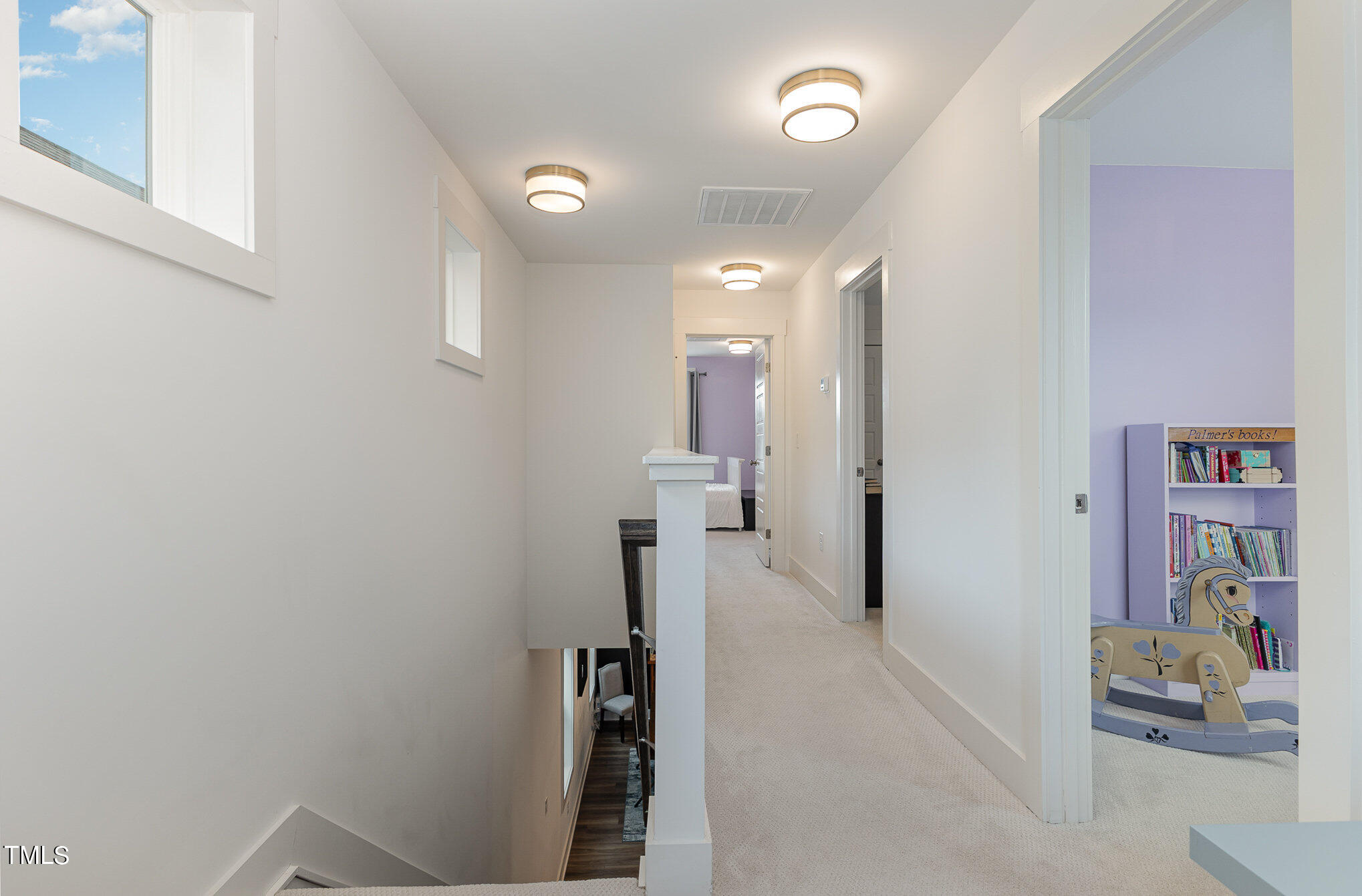 205 Daniel Ridge Road Wendell, NC 27591 - Photo 17 of 24 a view of a hallway with paintings on the wall