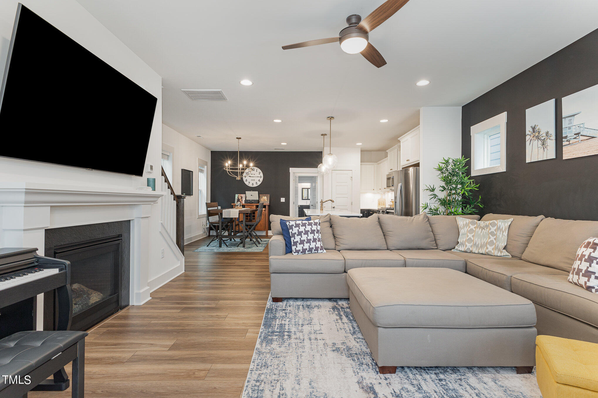 205 Daniel Ridge Road Wendell, NC 27591 - Photo 7 of 24 a living room with furniture a fireplace and a flat screen tv