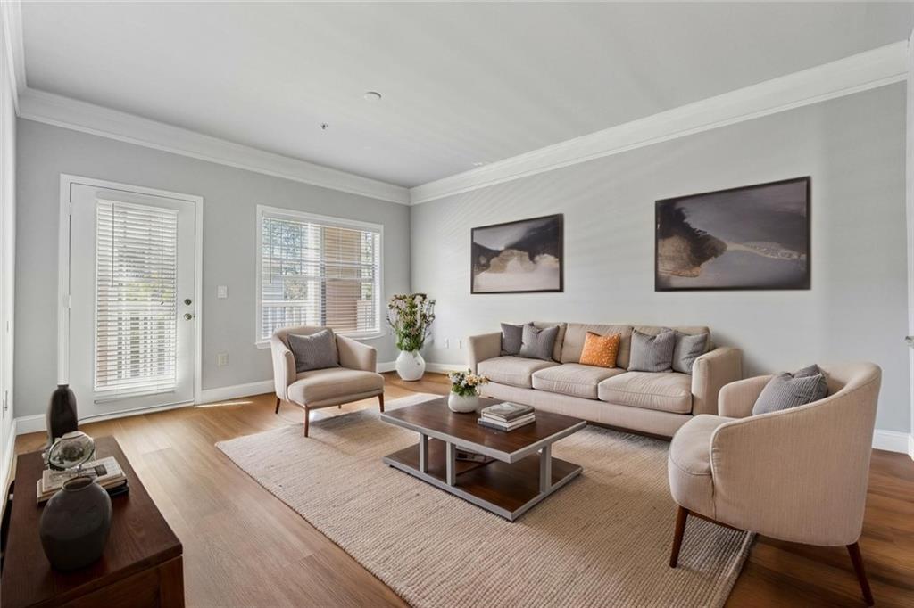 2700 Pine Tree Road Northeast, Unit 1115 Atlanta, GA 30324 - Photo 14 of 29 a living room with furniture wooden floor and a large window
