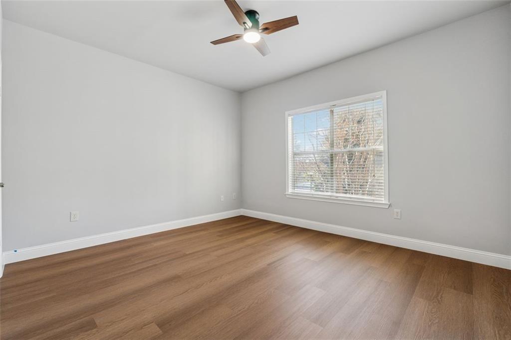 2700 Pine Tree Road Northeast, Unit 1115 Atlanta, GA 30324 - Photo 16 of 29 an empty room with wooden floor and windows