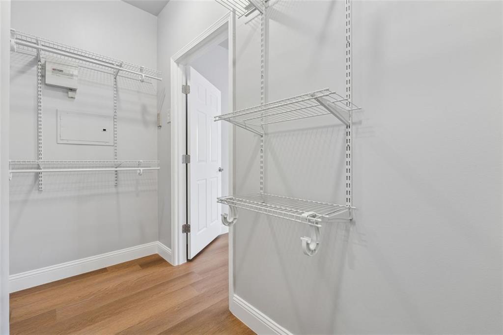 2700 Pine Tree Road Northeast, Unit 1115 Atlanta, GA 30324 - Photo 19 of 29 a view of a room with wooden floor and white walls