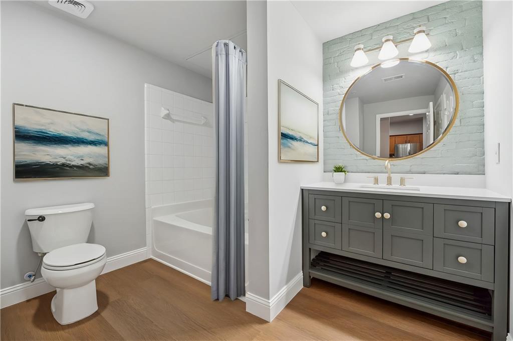 2700 Pine Tree Road Northeast, Unit 1115 Atlanta, GA 30324 - Photo 21 of 29 a bathroom with a toilet a sink and mirror