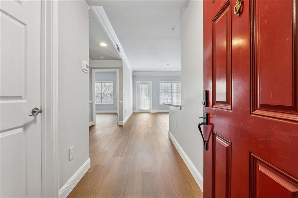 2700 Pine Tree Road Northeast, Unit 1115 Atlanta, GA 30324 - Photo 7 of 29 a view of a hallway with wooden floor and staircase