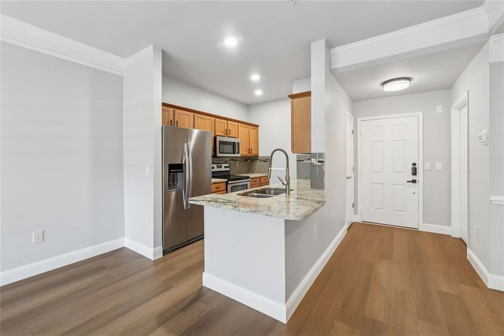 2700 Pine Tree Road Northeast, Unit 1115 Atlanta, GA 30324 - Photo 9 of 29 a kitchen with stainless steel appliances granite countertop a sink stove and refrigerator