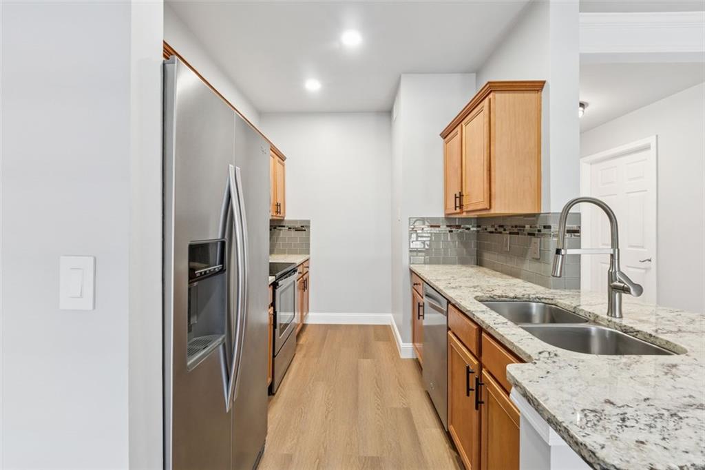 2700 Pine Tree Road Northeast, Unit 1115 Atlanta, GA 30324 - Photo 10 of 29 a kitchen with stainless steel appliances granite countertop a sink and a refrigerator