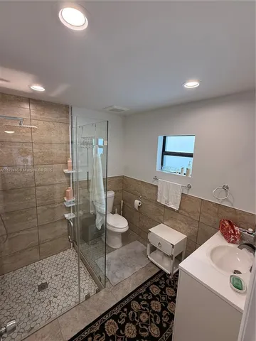 a room with a washing machine a sink and a counter top space