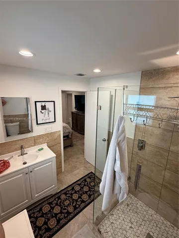 a bed room with a bed and a chair