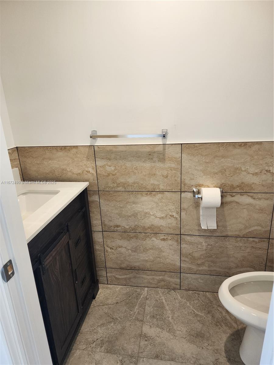 413 Southwest 10th Street Delray Beach, FL 33444 - Photo 16 of 16 a bathroom with a sink and a toilet