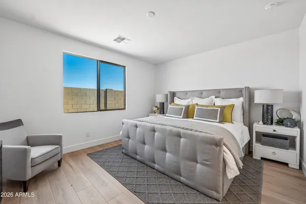 a bedroom with a bed and a couch