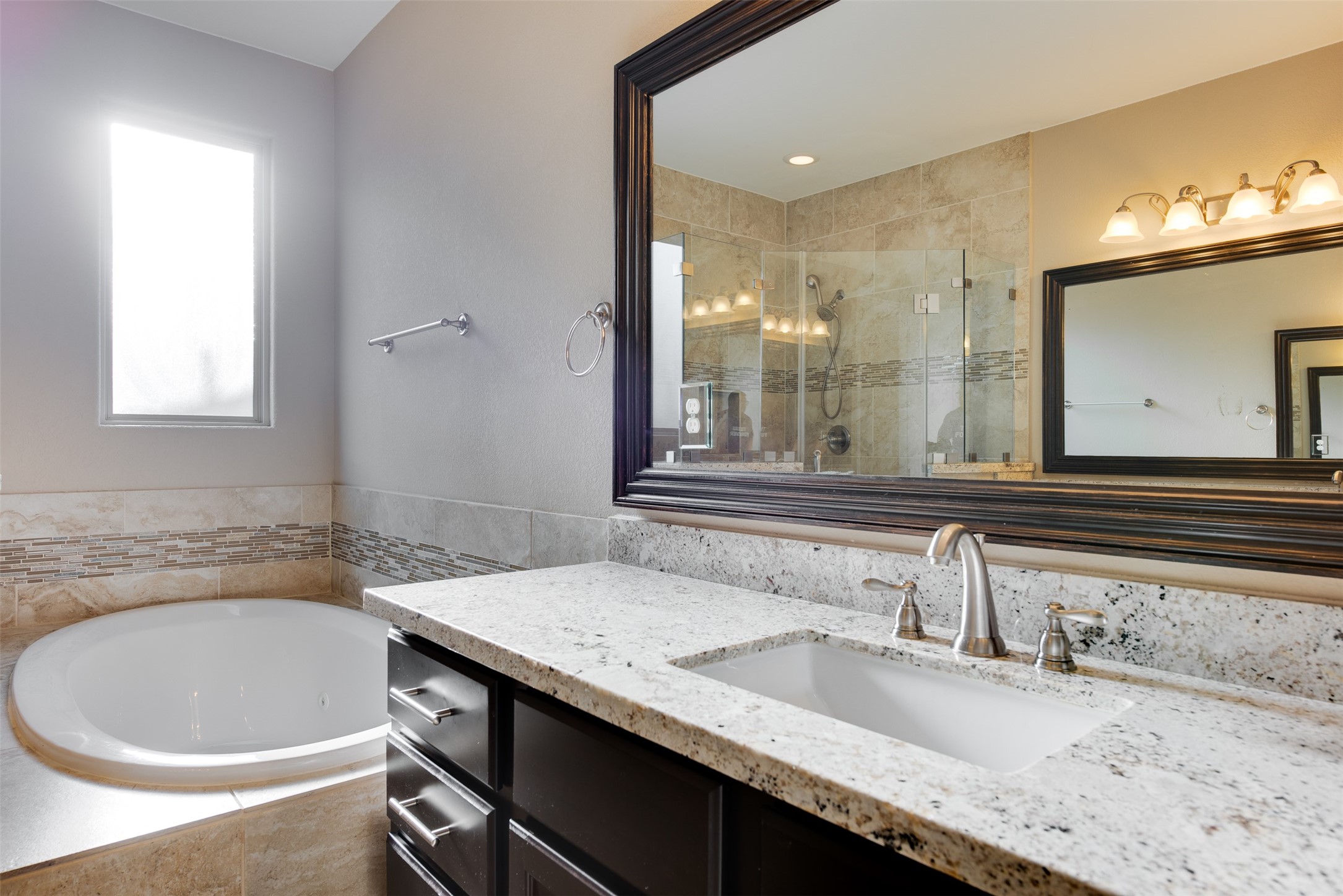 6105 Stillman Street Houston, TX 77007 - Photo 24 of 33 a bathroom with a granite countertop sink a mirror and a bathtub