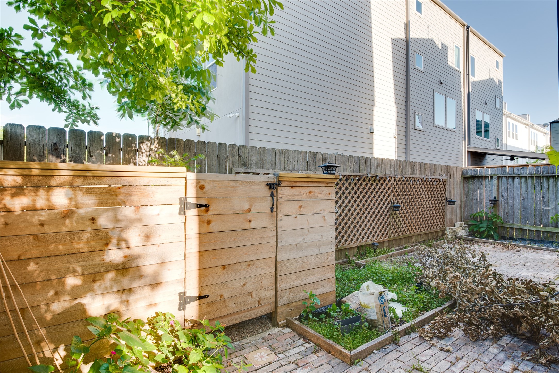 6105 Stillman Street Houston, TX 77007 - Photo 33 of 33 a view of a house with a small yard and wooden fence