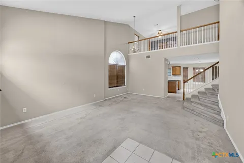 a view of a livingroom with an empty space and a window
