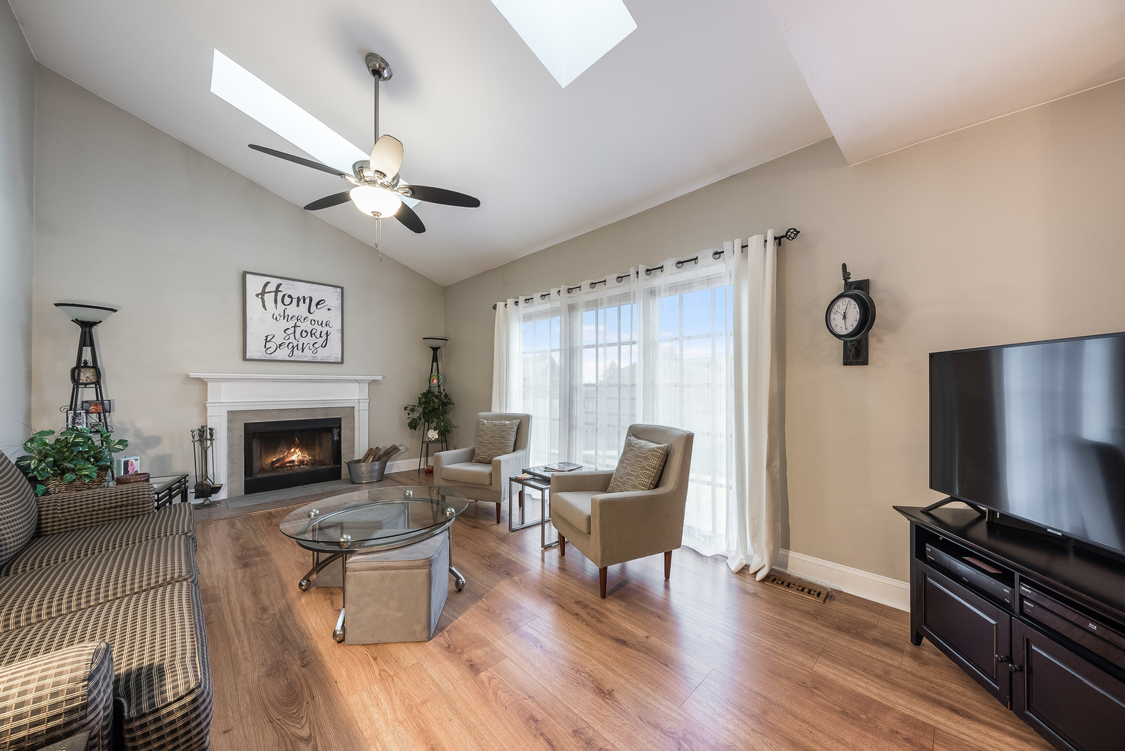716 Pinehurst Lane Oswego, IL 60543 - Photo 12 of 25 a living room with furniture a fireplace and a flat screen tv