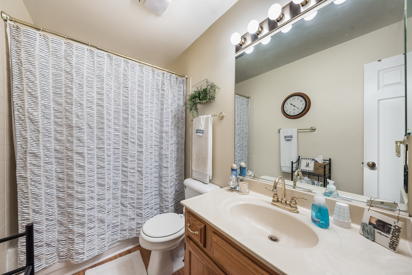 716 Pinehurst Lane Oswego, IL 60543 - Photo 16 of 25 a bathroom with a sink a toilet and shower curtain