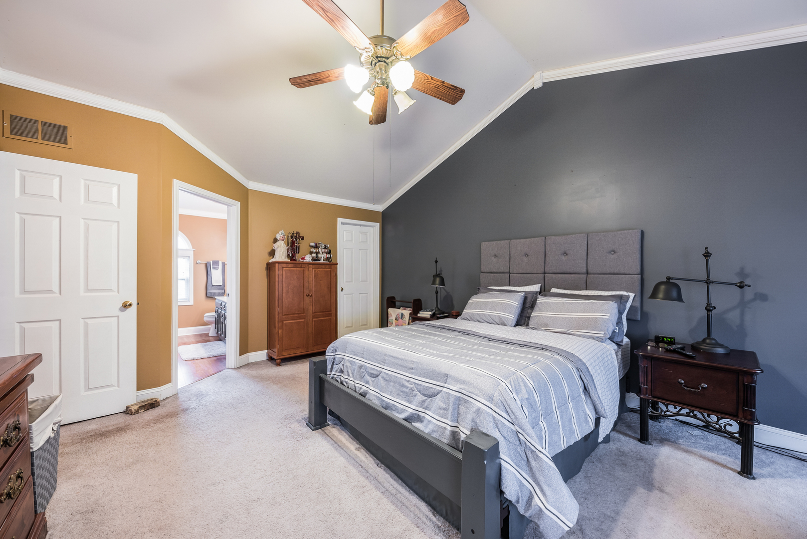 716 Pinehurst Lane Oswego, IL 60543 - Photo 19 of 25 a bedroom with a bed and a chandelier