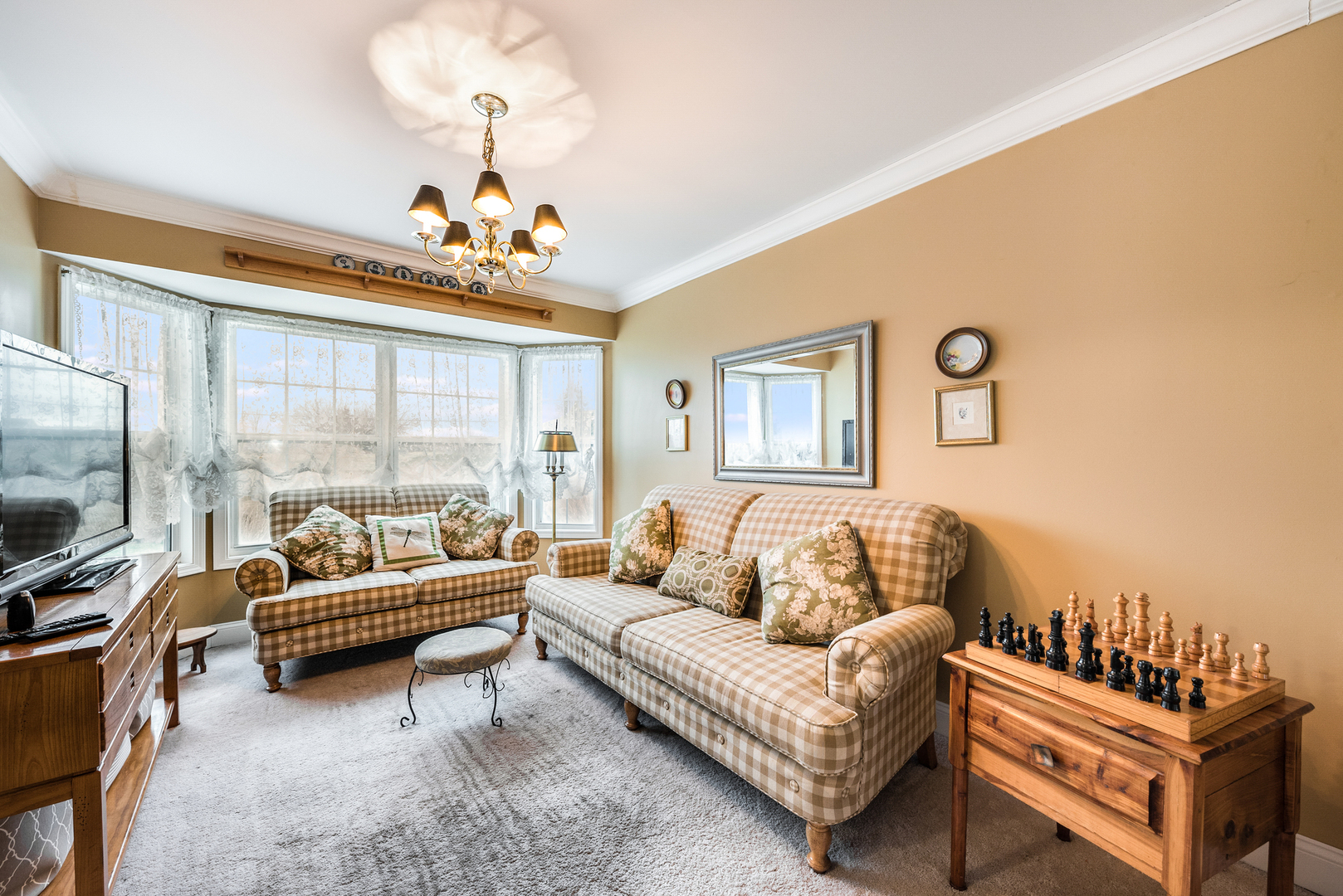 716 Pinehurst Lane Oswego, IL 60543 - Photo 5 of 25 a living room with furniture a flat screen tv and a window
