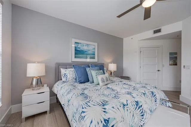 a bedroom with a bed and a lamp